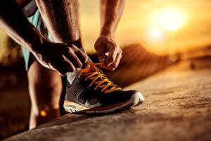 Runner tying running shoes